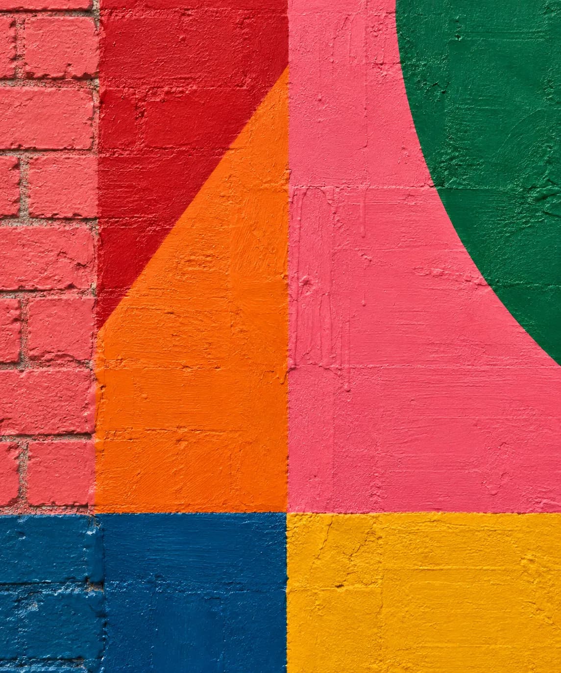A section of painted wall in saturated colour blocks and geometric shapes