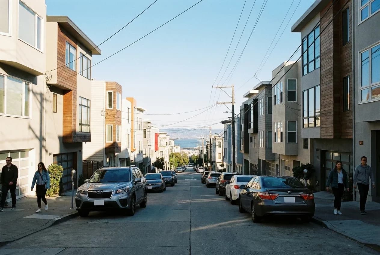 A steep San Francisco street looking down towards the bay with houses on both sides