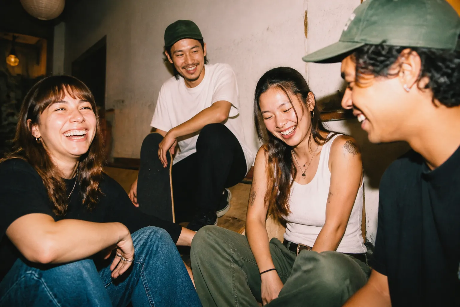 Friends laughing together at a casual activity spot