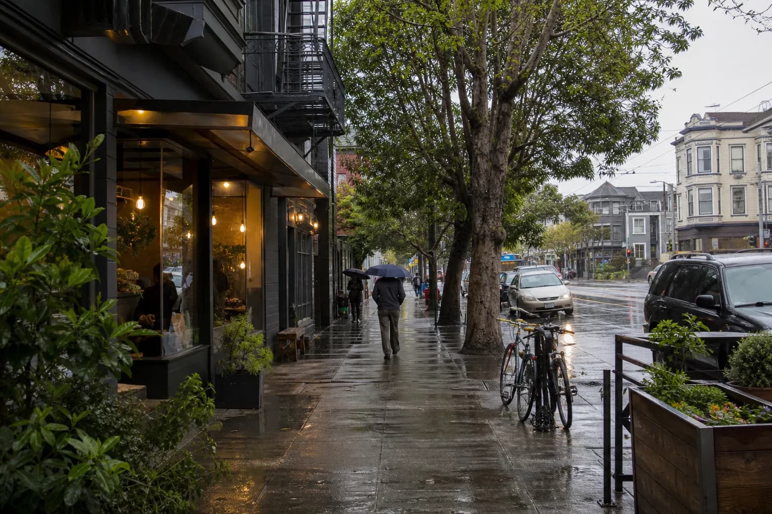 Rainy Hayes Valley street with café windows, wet sidewalks, and compact storefronts