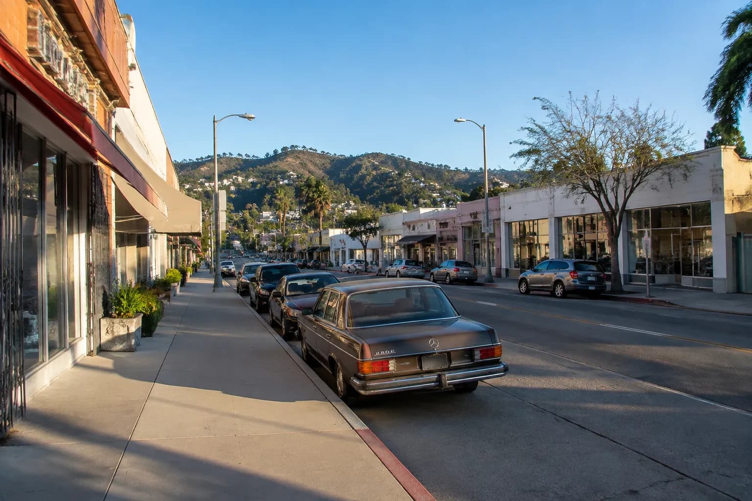 Sunset Boulevard in Silver Lake with parked cars and hills in the background