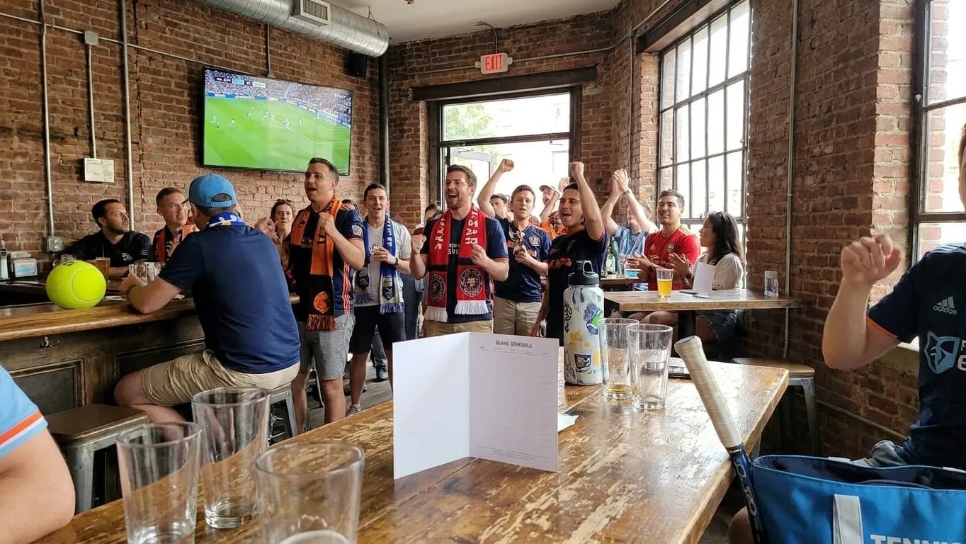 A bright Queens local-life scene connected to MLS All Star Game Energy at US Open Soccer Bars.