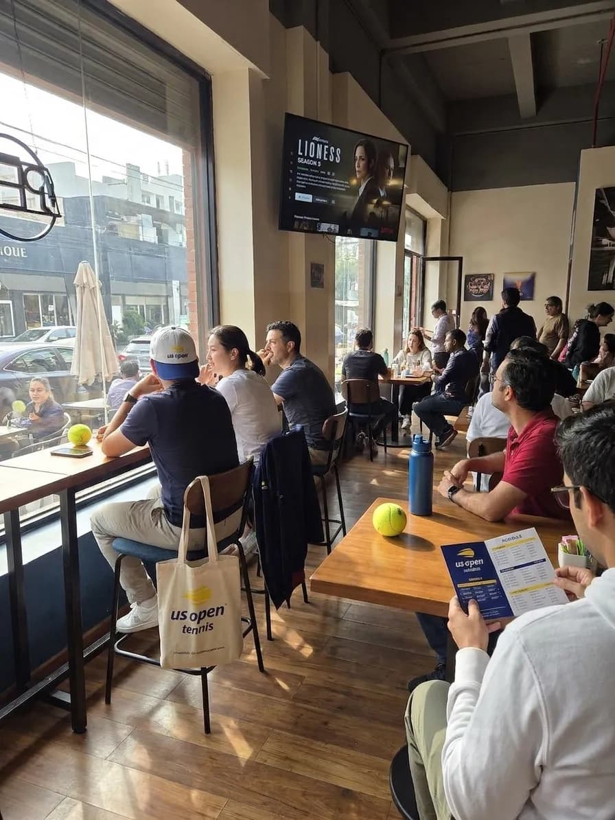 A bright Queens local-life scene connected to Lioness Season 3 Viewing: NYC Streaming Cafes During US Open.
