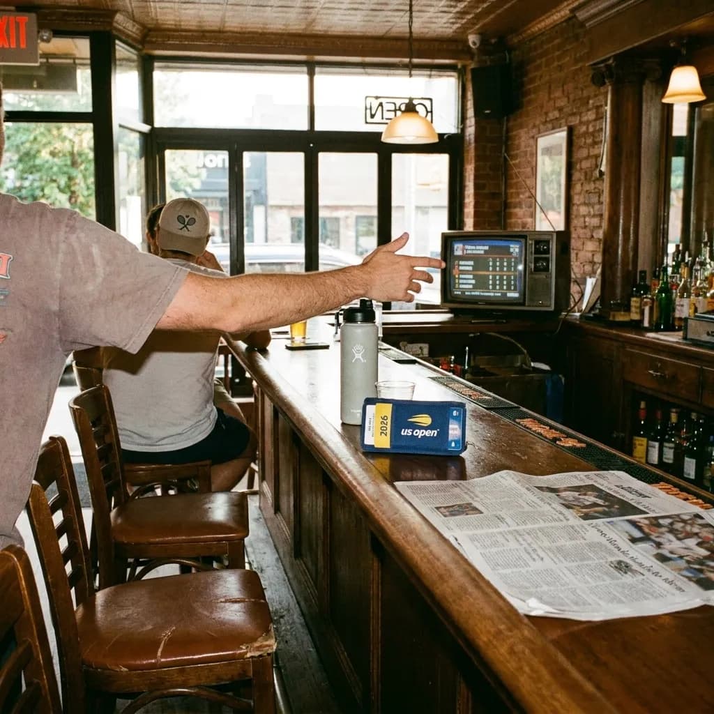 A bright Queens local-life scene inspired by queens new york bar interior, with subtle US Open details.