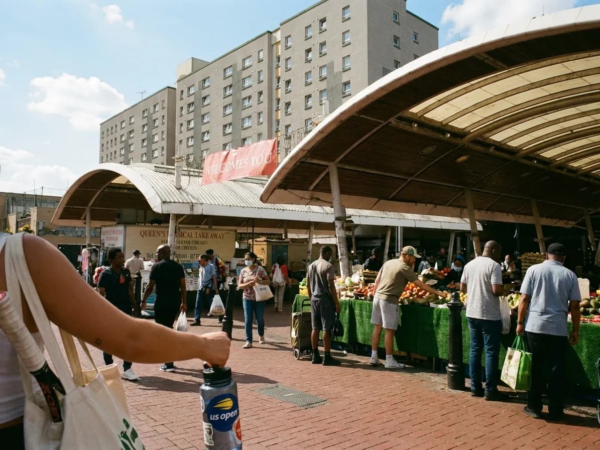A bright Queens local-life scene inspired by queens street market, with subtle US Open details.