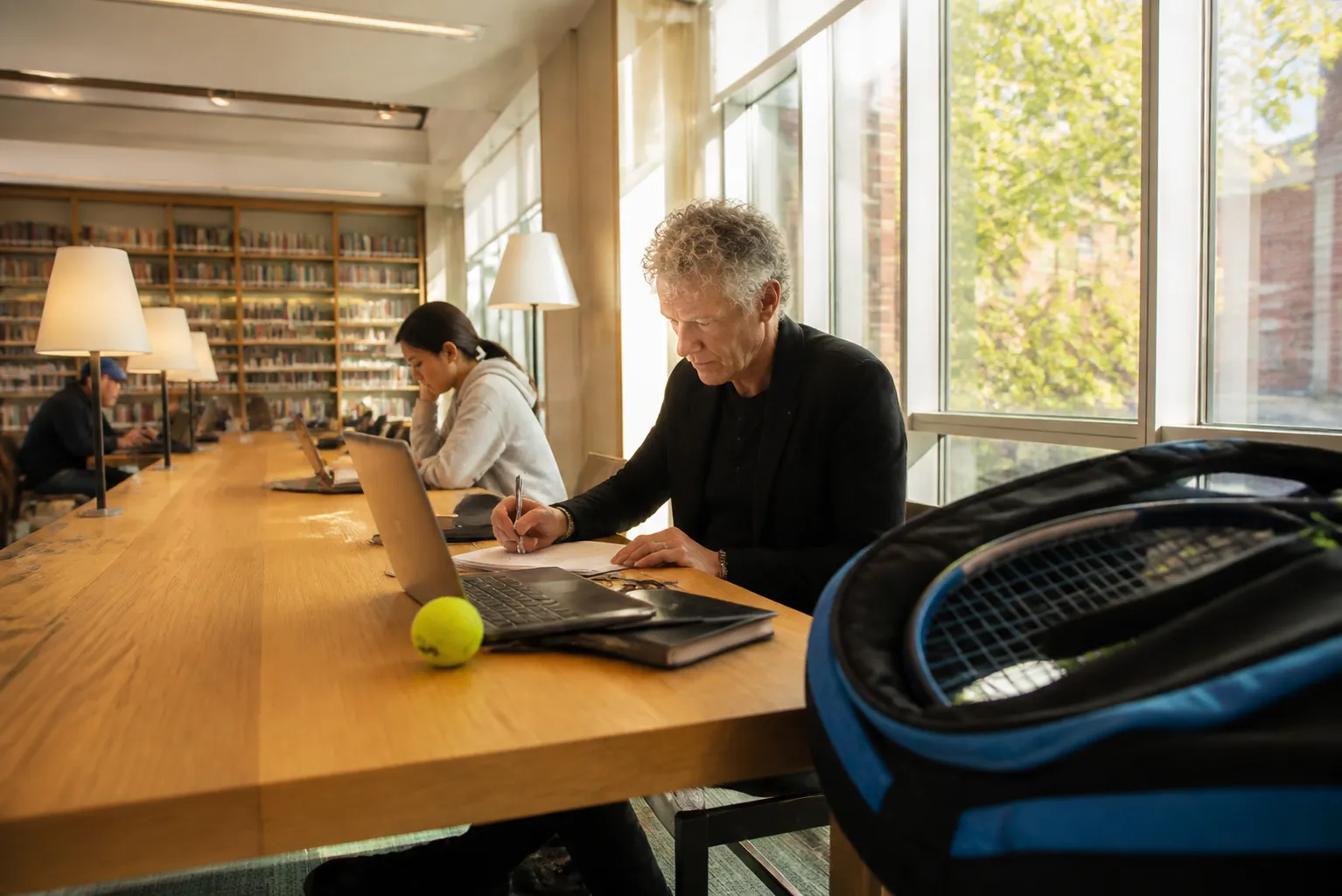 A bright Queens local-life scene connected to Lindsey Buckingham Near US Open 2026: Quiet Library Work Tables Between Matches.