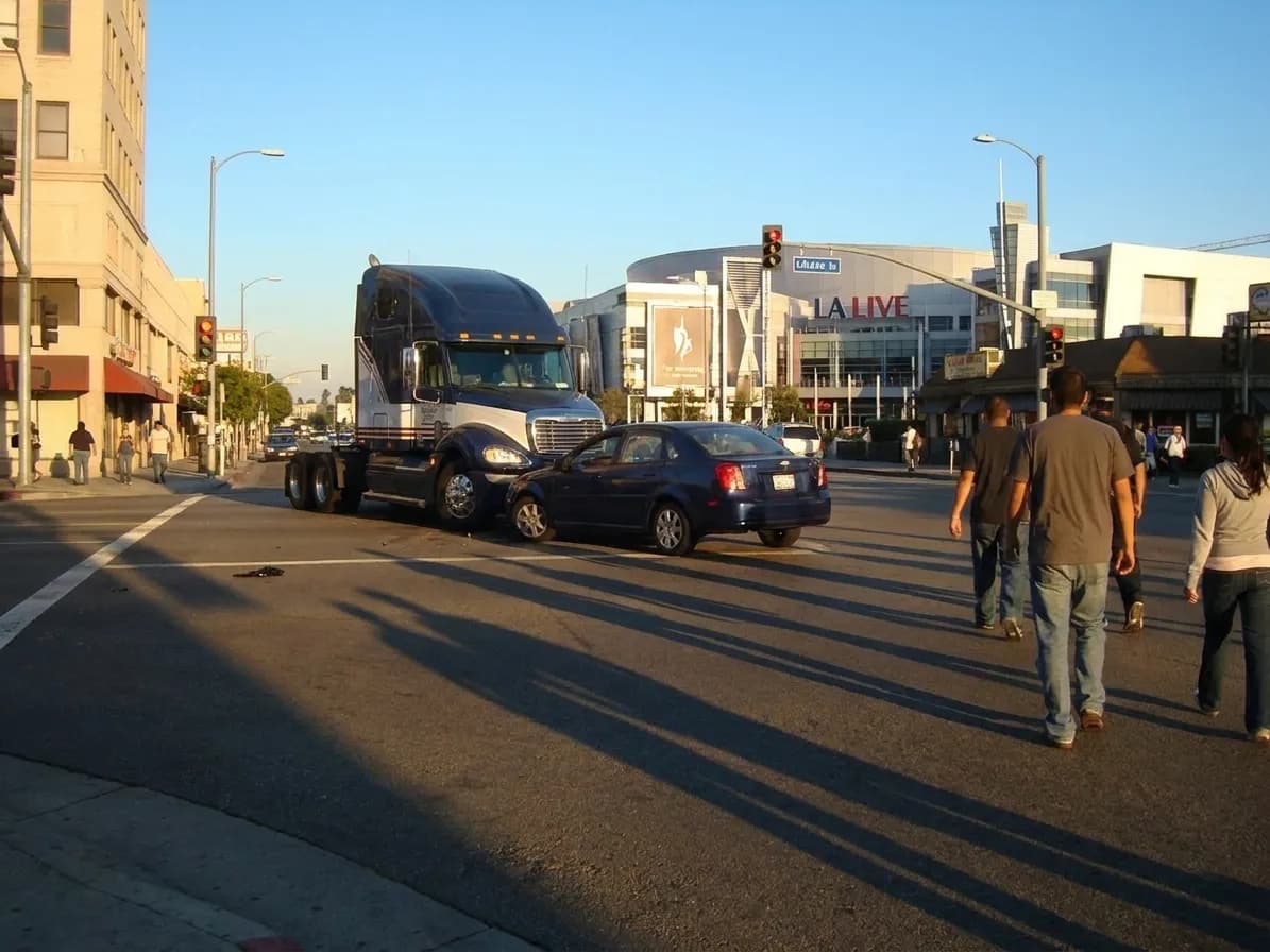 Figueroa Street in downtown Los Angeles with LA Live complex and Metro station entrance visible in the late afternoon