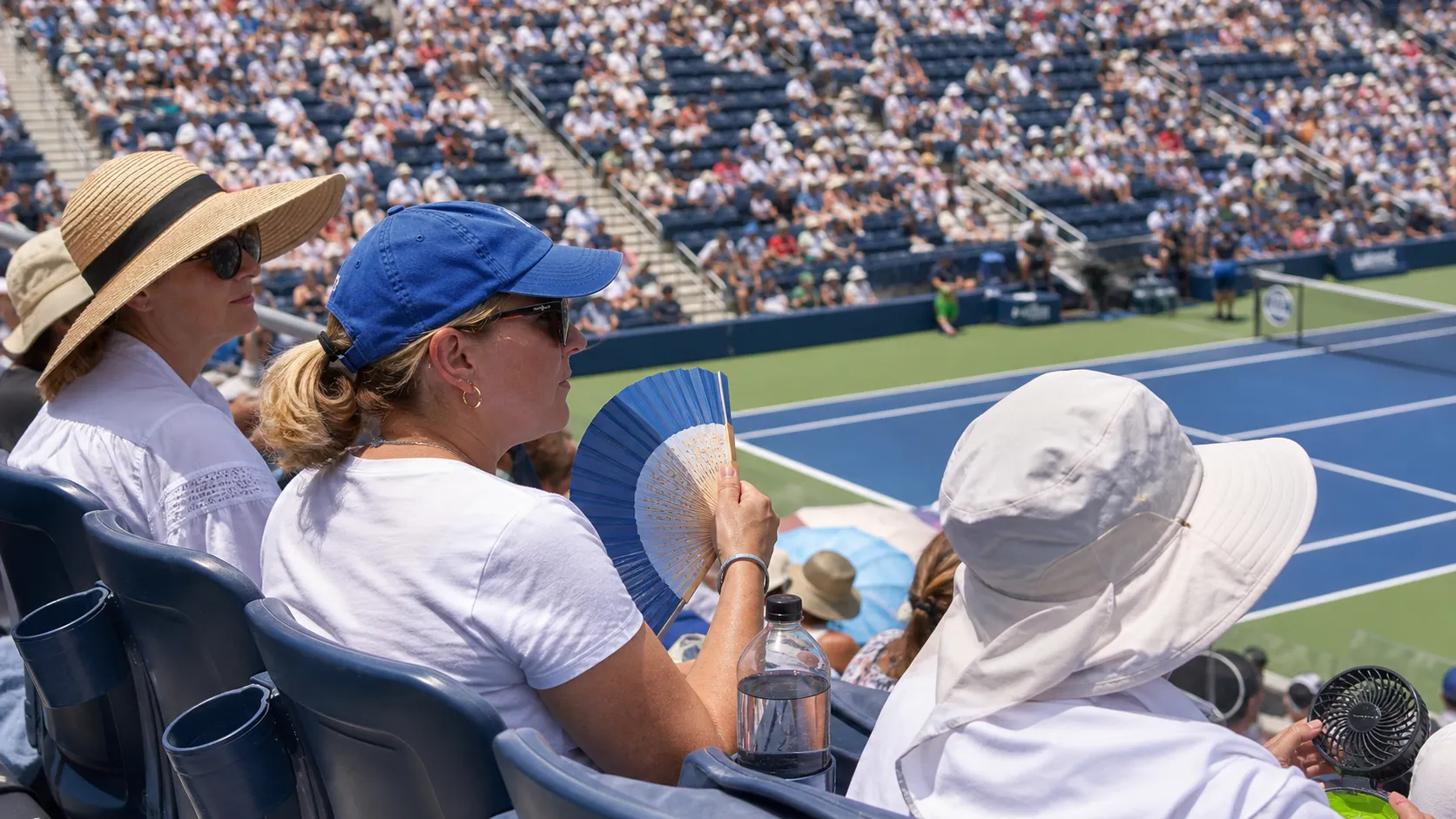 Photorealistic US Open tennis scene for US Open Heat Strategy: Hydration, Shade, and Smarter Session Planning.