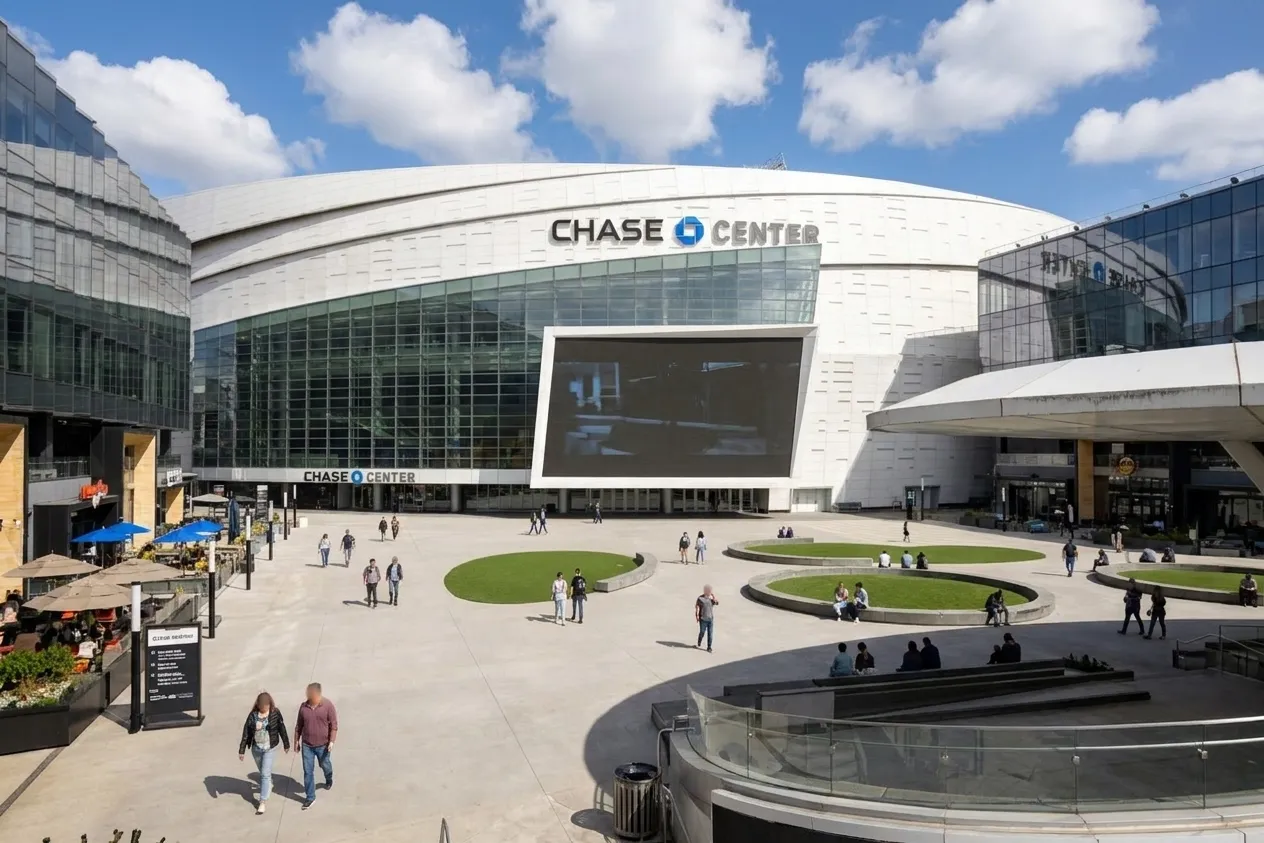 Thrive City outdoor plaza at Chase Center with seating areas and arena entrance in background during afternoon