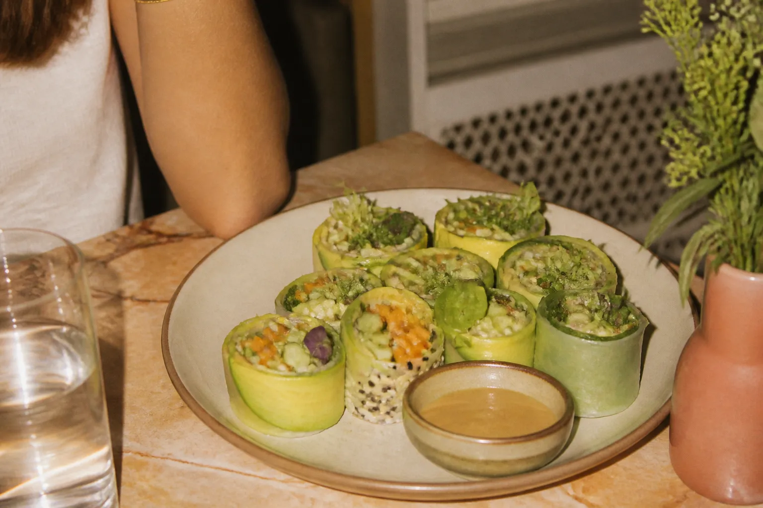 Colorful avocado and cucumber vegetable rolls arranged on a plate