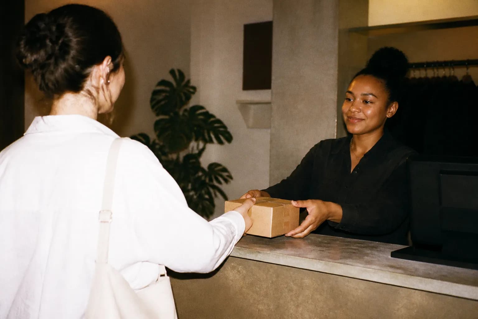 A customer service return counter with a small package resting on top