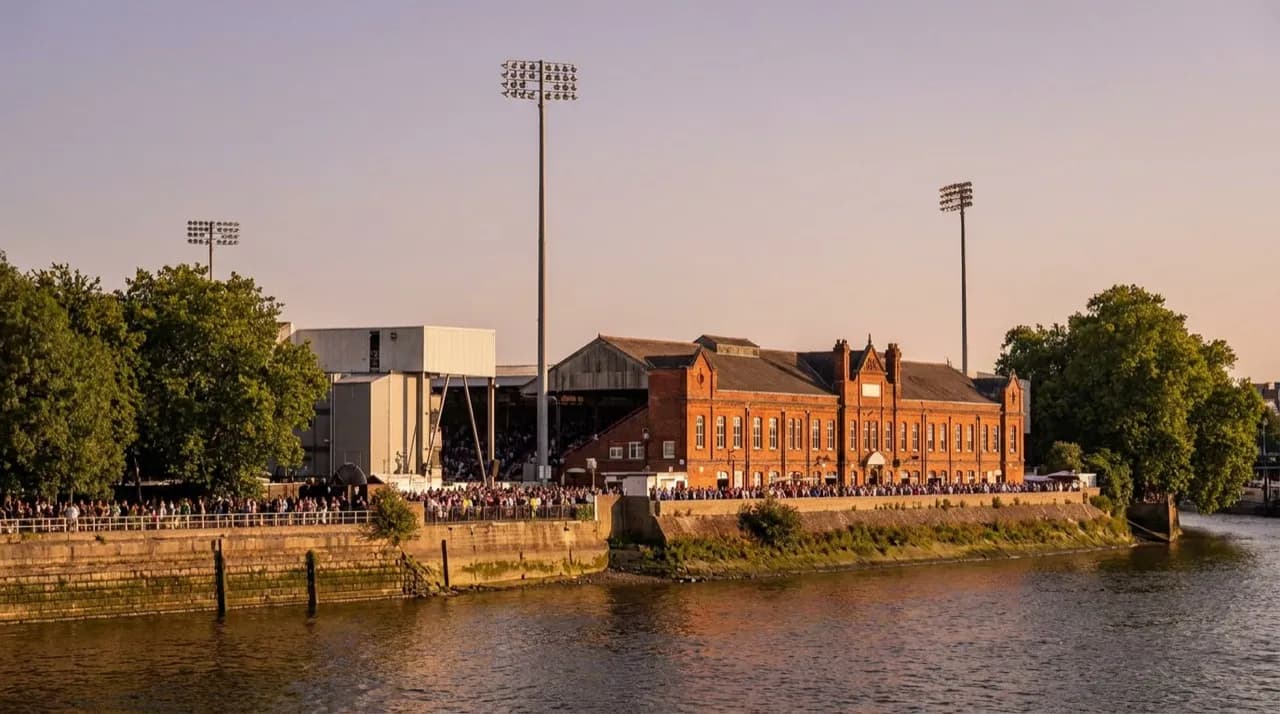 Craven Cottage stadium in Fulham, London, riverside facade and pitch on a cloudy afternoon