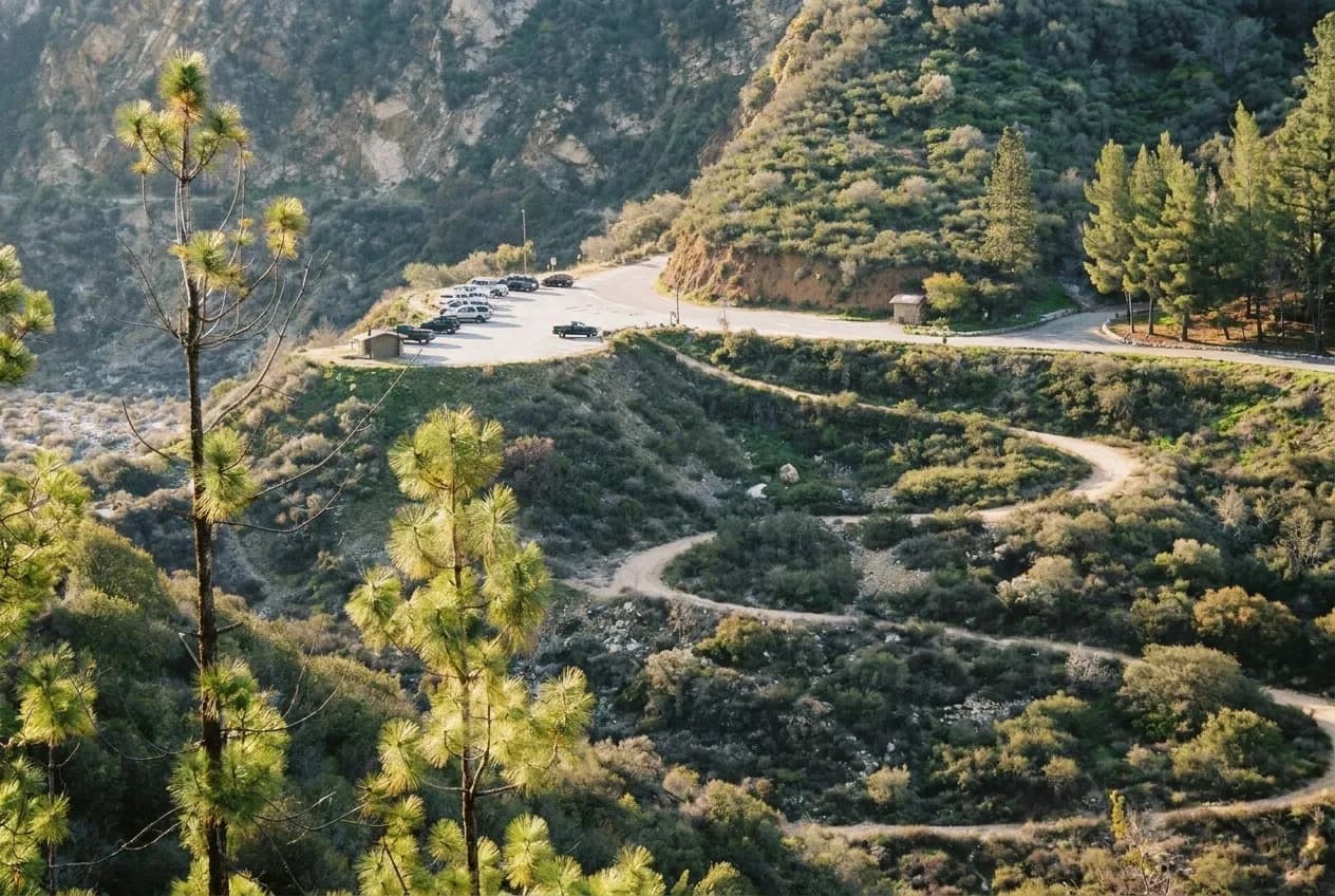 Trailhead parking lot in San Gabriel Mountains on weekend morning