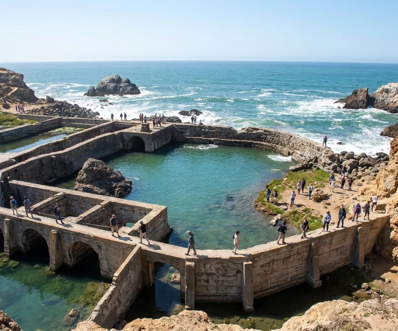 Sutro Baths concrete ruins and tidal pools at Lands End with visitors exploring the historic site