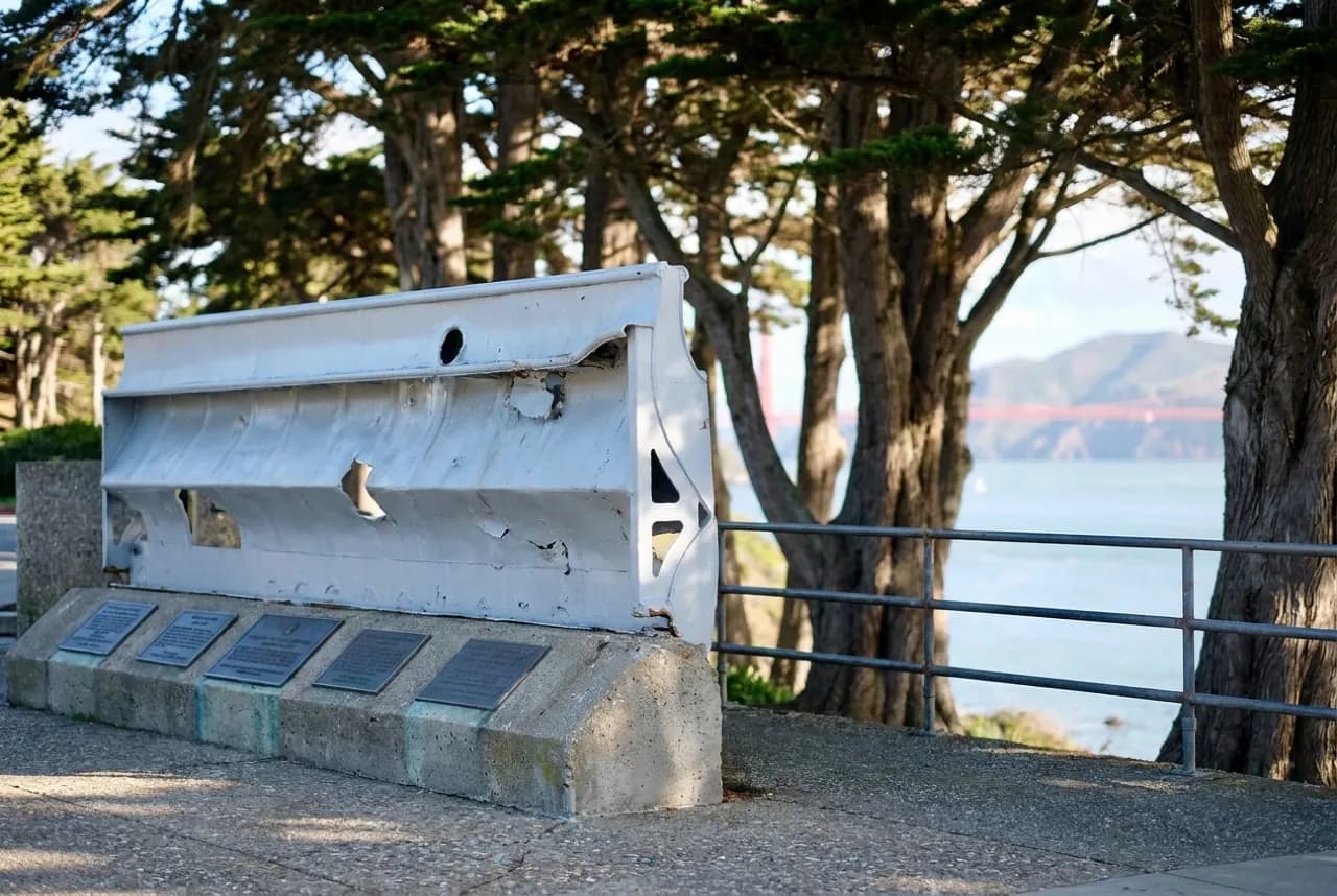 Lands End Lookout building and viewing deck with Golden Gate Bridge visible through coastal fog