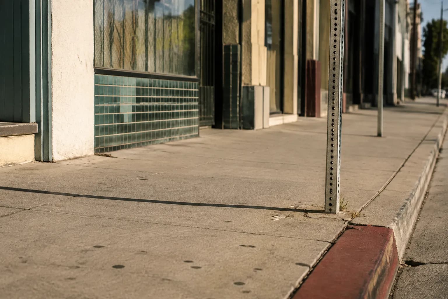 Figueroa Street sidewalk in Highland Park with storefronts and afternoon sunlight