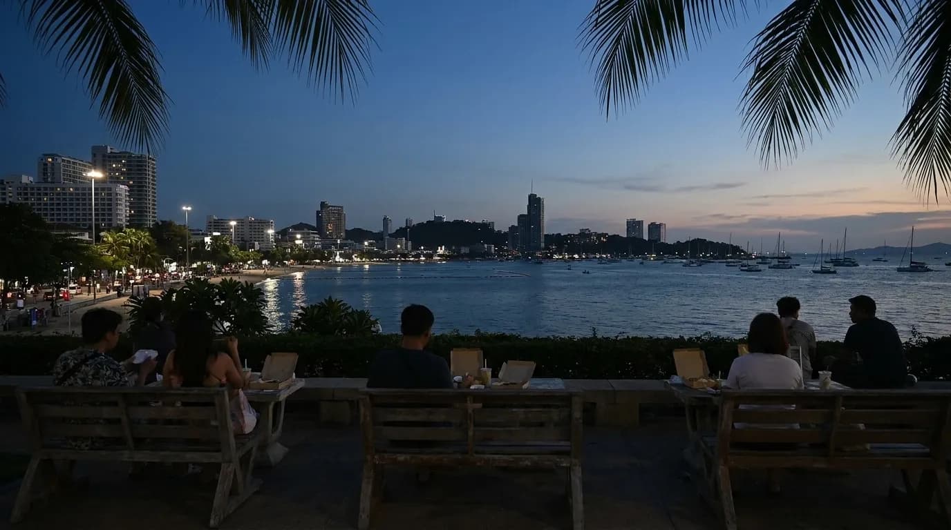 Evening view of bayside benches at Peacock Park in Coconut Grove with people eating takeout