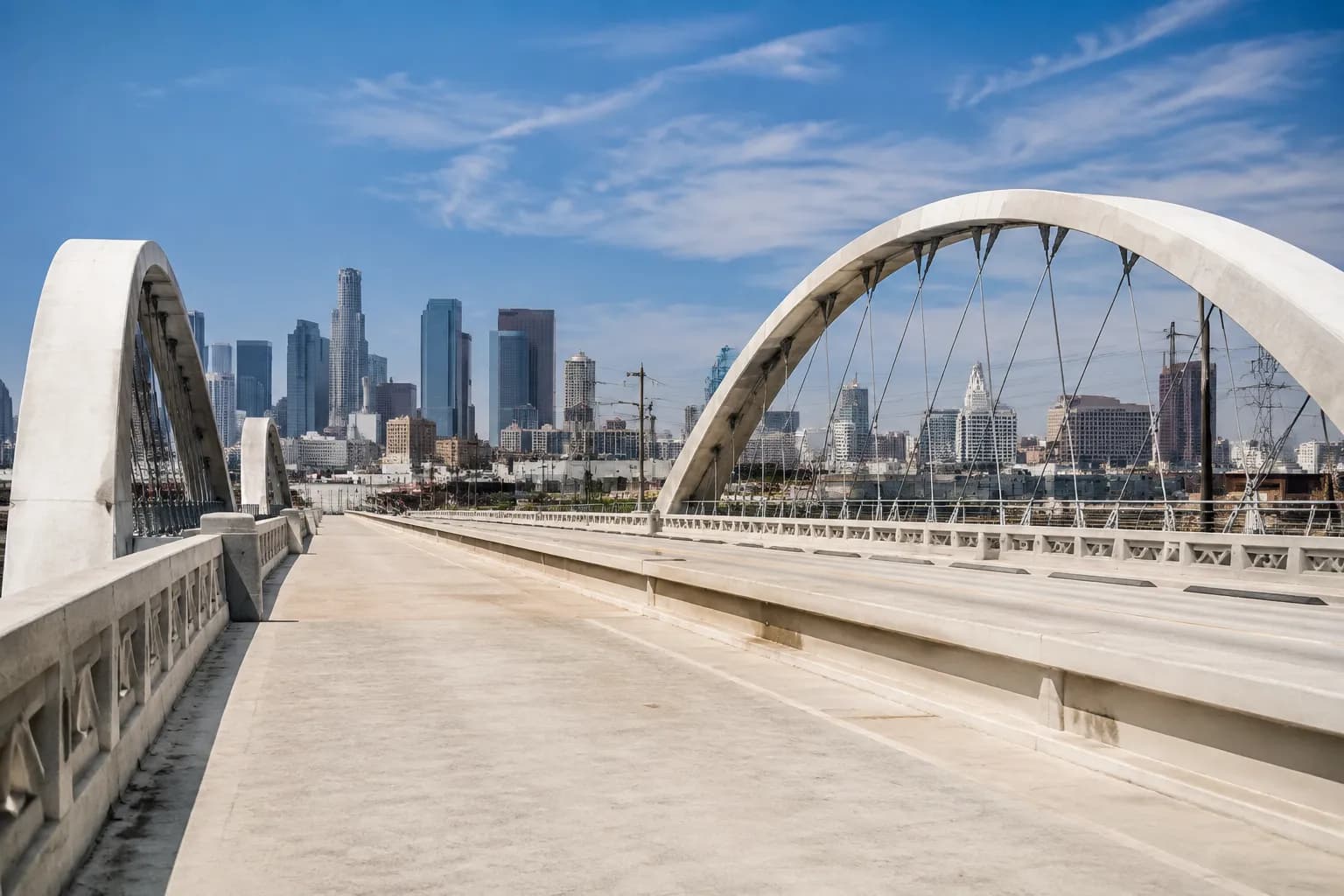 Sixth Street Bridge pedestrian walkway with view toward Boyle Heights and downtown Los Angeles skyline