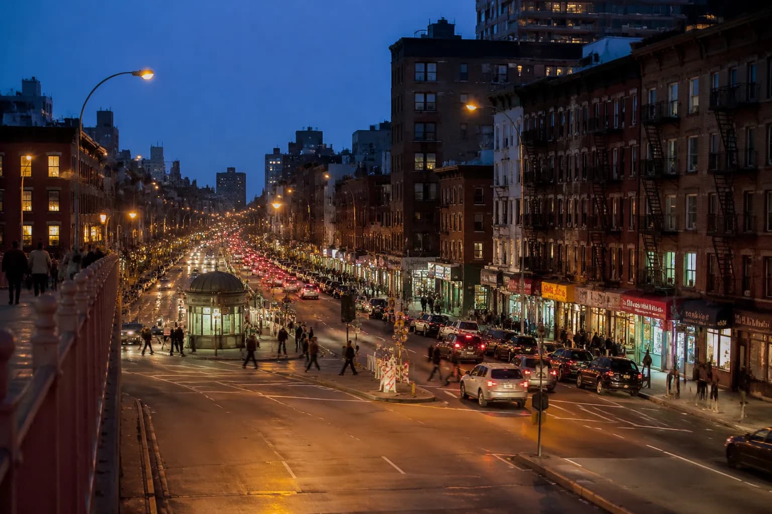 Delancey Street in the Lower East Side at evening with storefronts and traffic