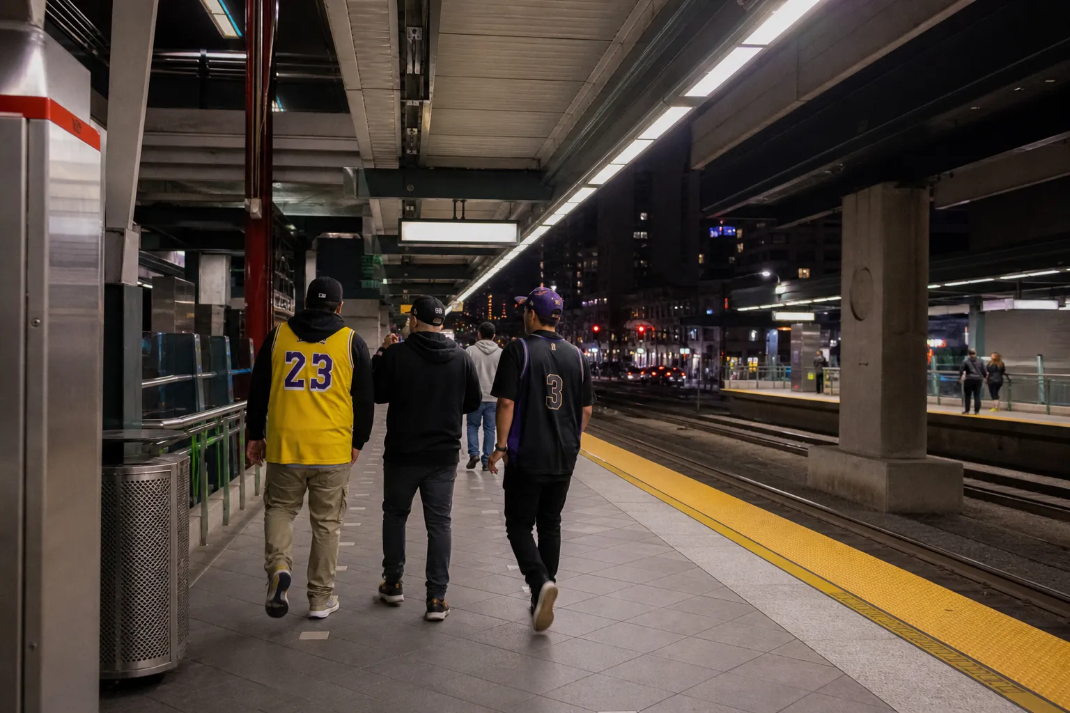 Late evening Los Angeles Metro platform with fans heading toward a basketball game