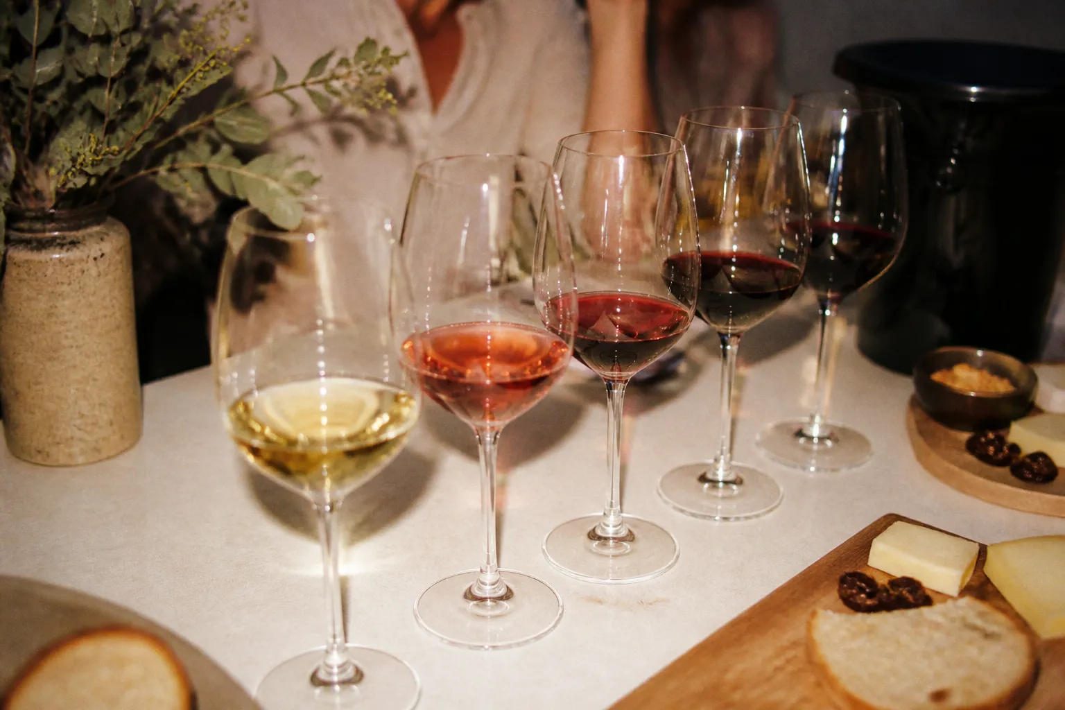 A neat flight of wine glasses arranged on a tasting table with soft daylight