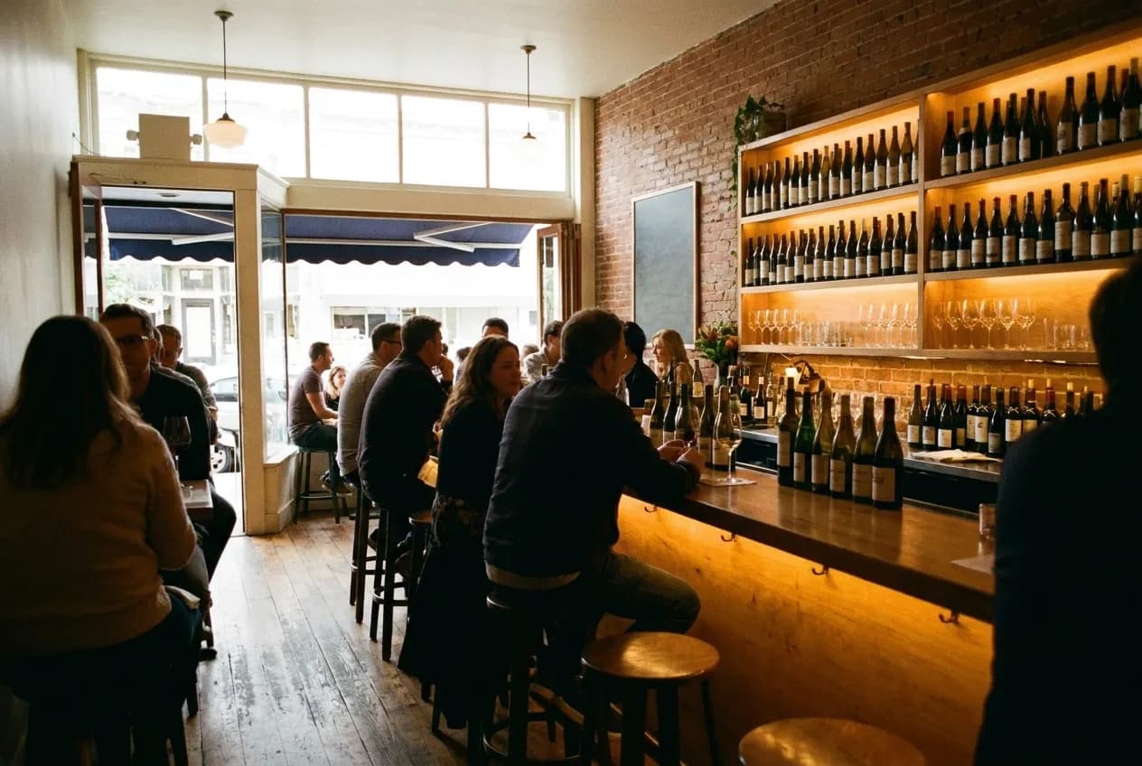 A small wine bar with bottles along a back shelf and a warm-lit counter in San Francisco